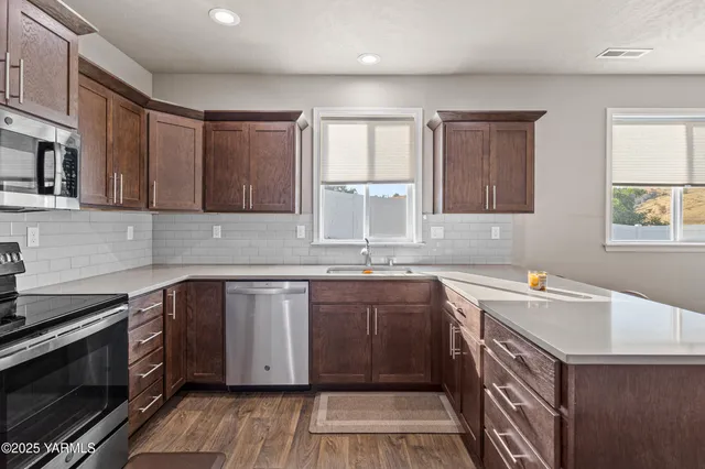 a kitchen with a sink stove and cabinets