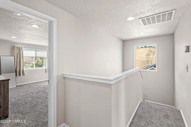 a spacious bedroom with a bed and a window