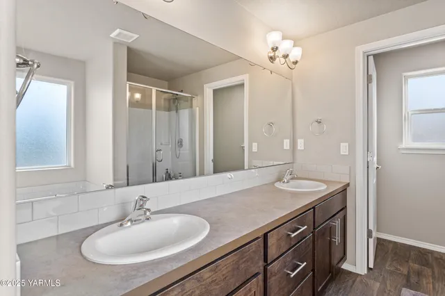 a view of an empty room with closet and a window
