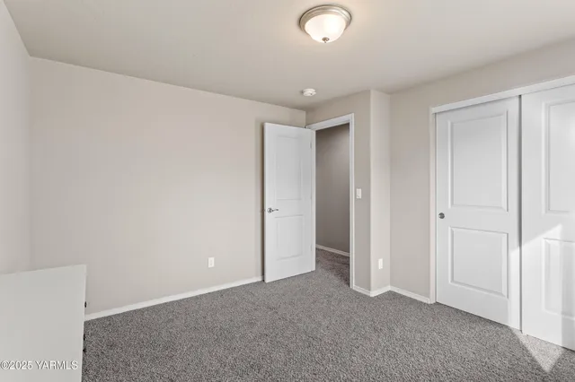 a bedroom with a bed a desk and chair