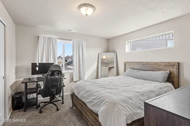 a bedroom with a bed and a large mirror