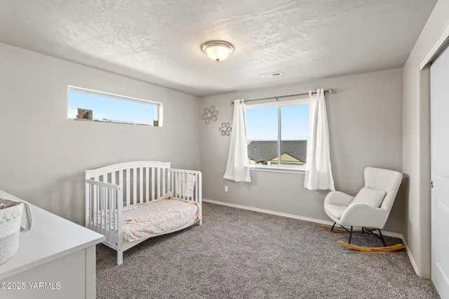 a spacious bedroom with a bed and furniture