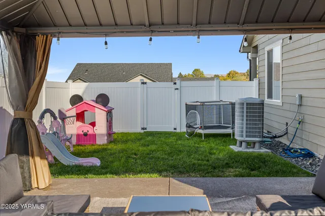 a view of a patio with a table and chairs under an umbrella