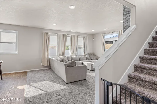 a living room with furniture and a hard wood floor