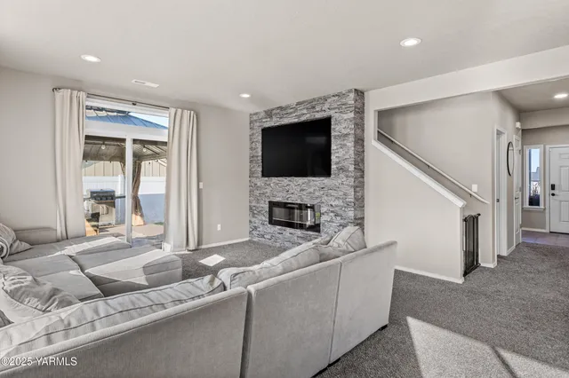 a living room with furniture and a flat screen tv