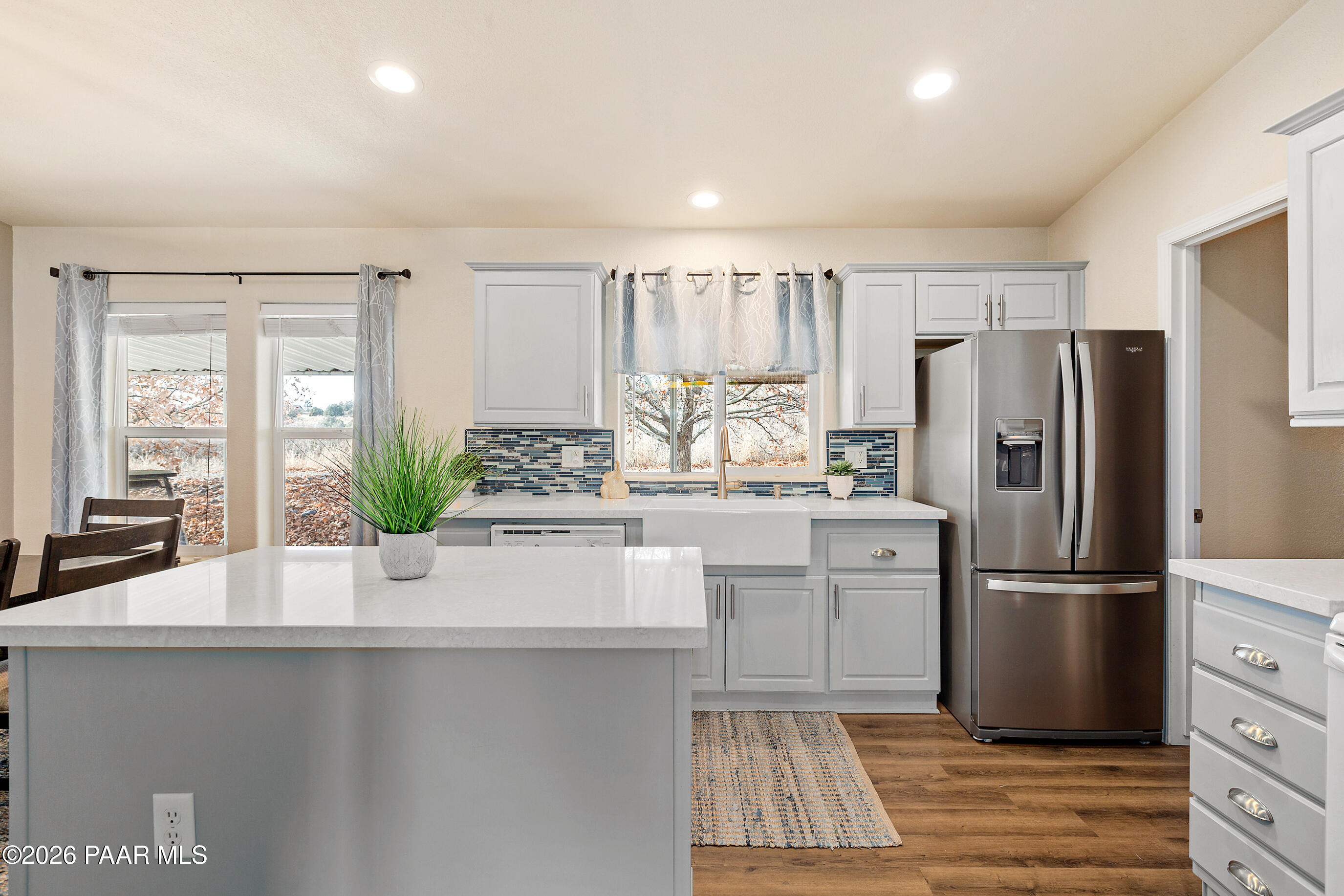 11250 East State Rte 69 Dewey, AZ 86327 - Photo 13 of 38 a kitchen with kitchen island a counter top space wooden floor and stainless steel appliances