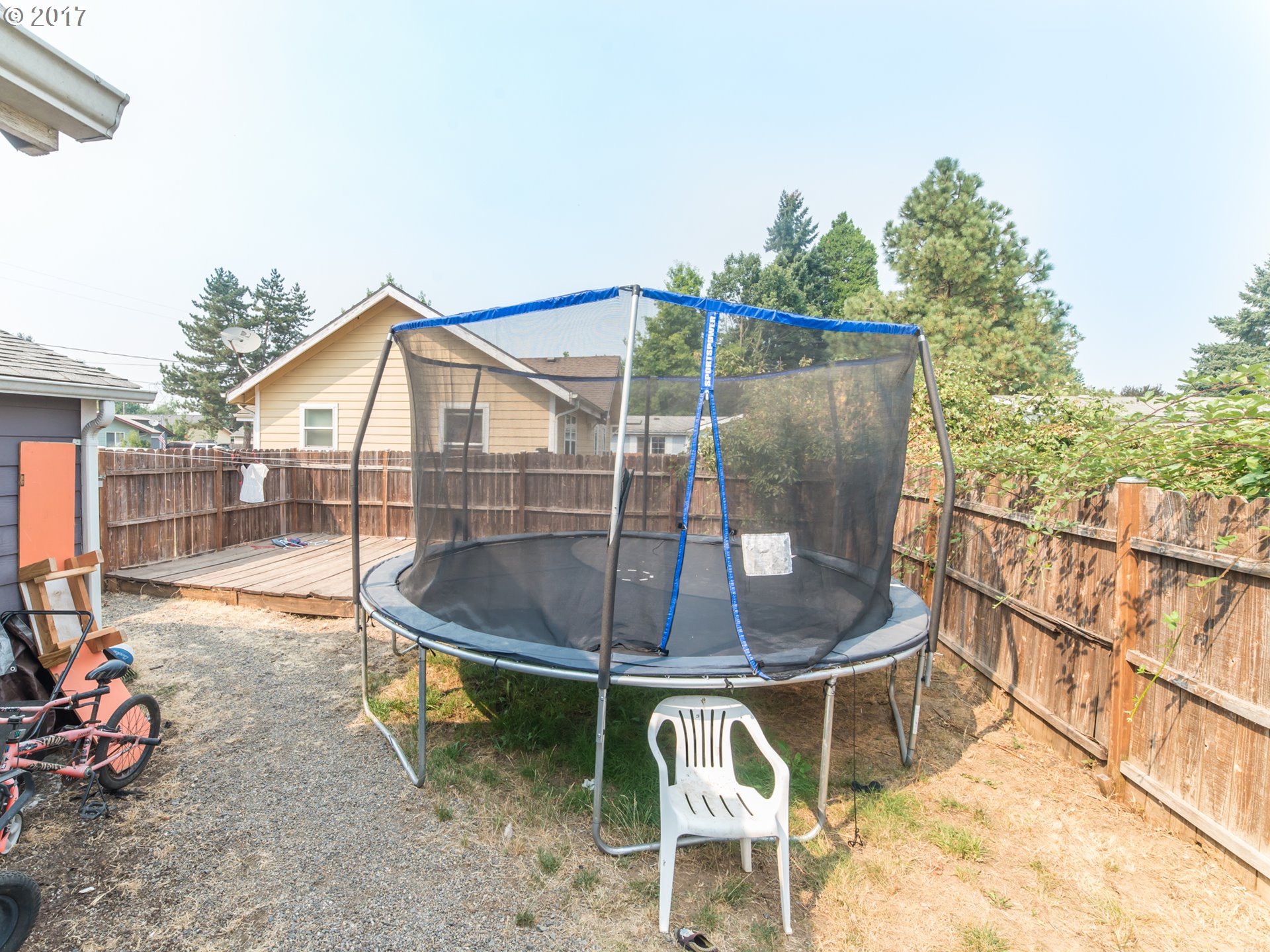 223 57th Street Springfield, OR 97478 - Photo 7 of 8 a backyard of a house with table and chairs