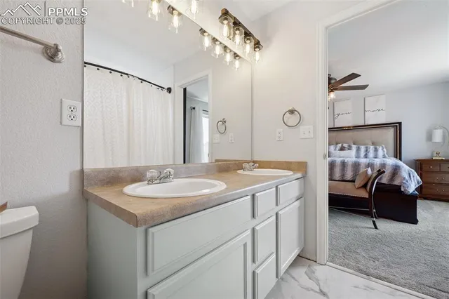 a en suite bathroom with a sink and a mirror