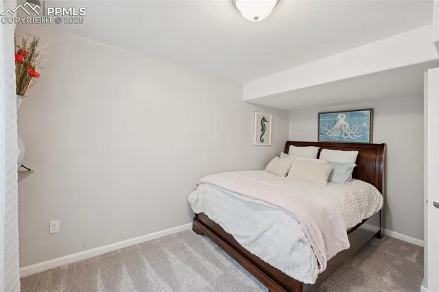 a bedroom with a bed and a night stand