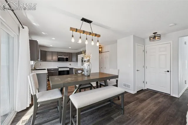 a view of a dining room with furniture and wooden floor