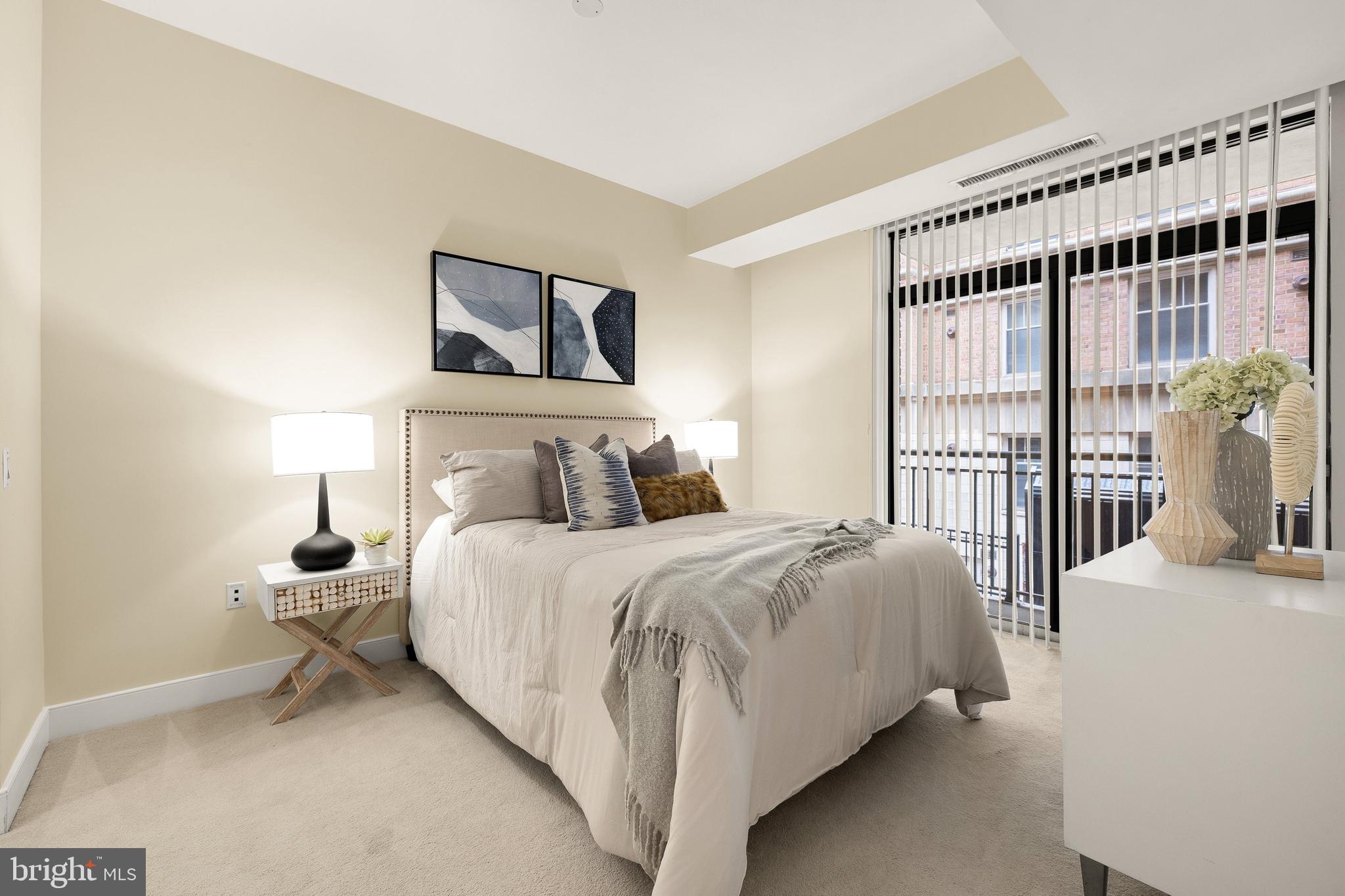 2425 L Street Northwest, Unit 234 Washington, DC 20037 - Photo 11 of 23 a bedroom with a large bed and a large window