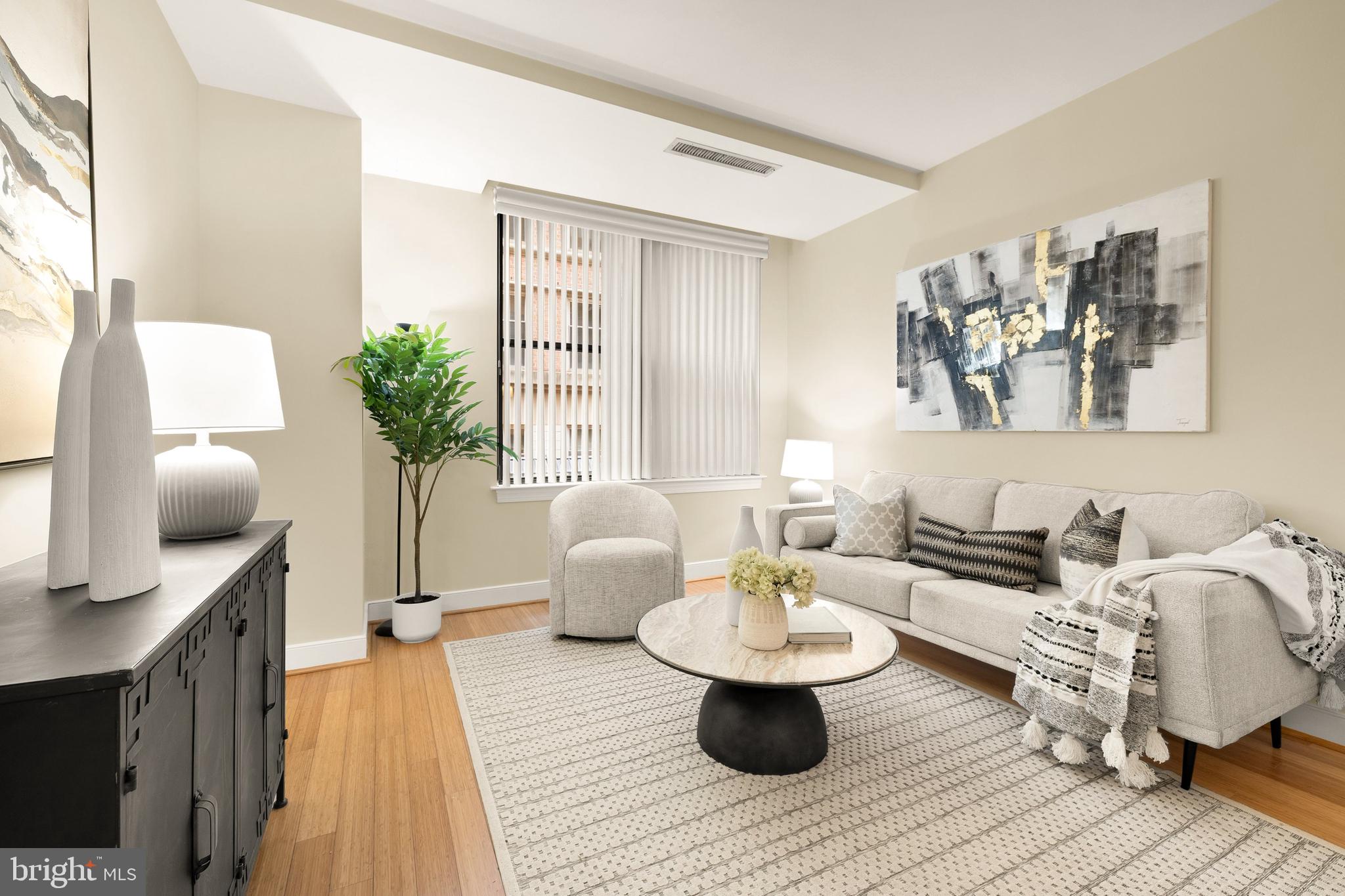 2425 L Street Northwest, Unit 234 Washington, DC 20037 - Photo 8 of 23 a living room with furniture and wooden floor