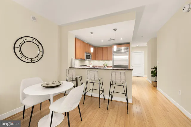 a kitchen with granite countertop white cabinets and stainless steel appliances
