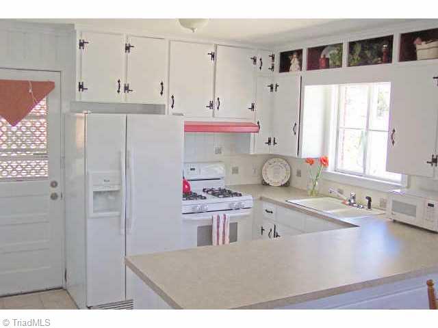 1431 Capri Road Southwest Winston-Salem, NC 27103 - Photo 2 of 9 Other. Bright and white kitchen with gas oven/range. Fridge stays