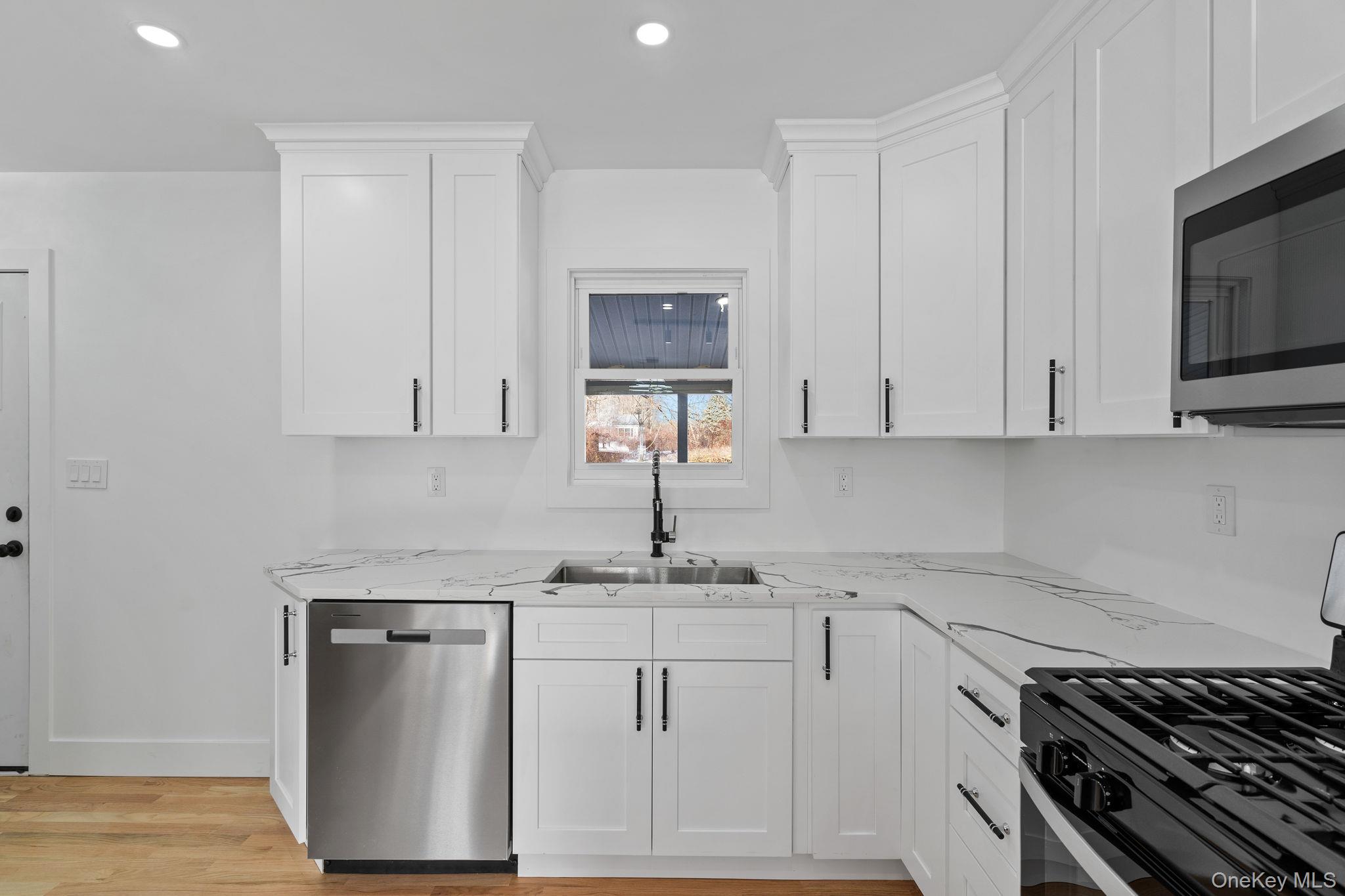 52 Rudolph Road Modena, NY 12548 - Photo 13 of 46 Kitchen with appliances with stainless steel finishes, white cabinets, light wood-style flooring, recessed lighting, and light stone countertops