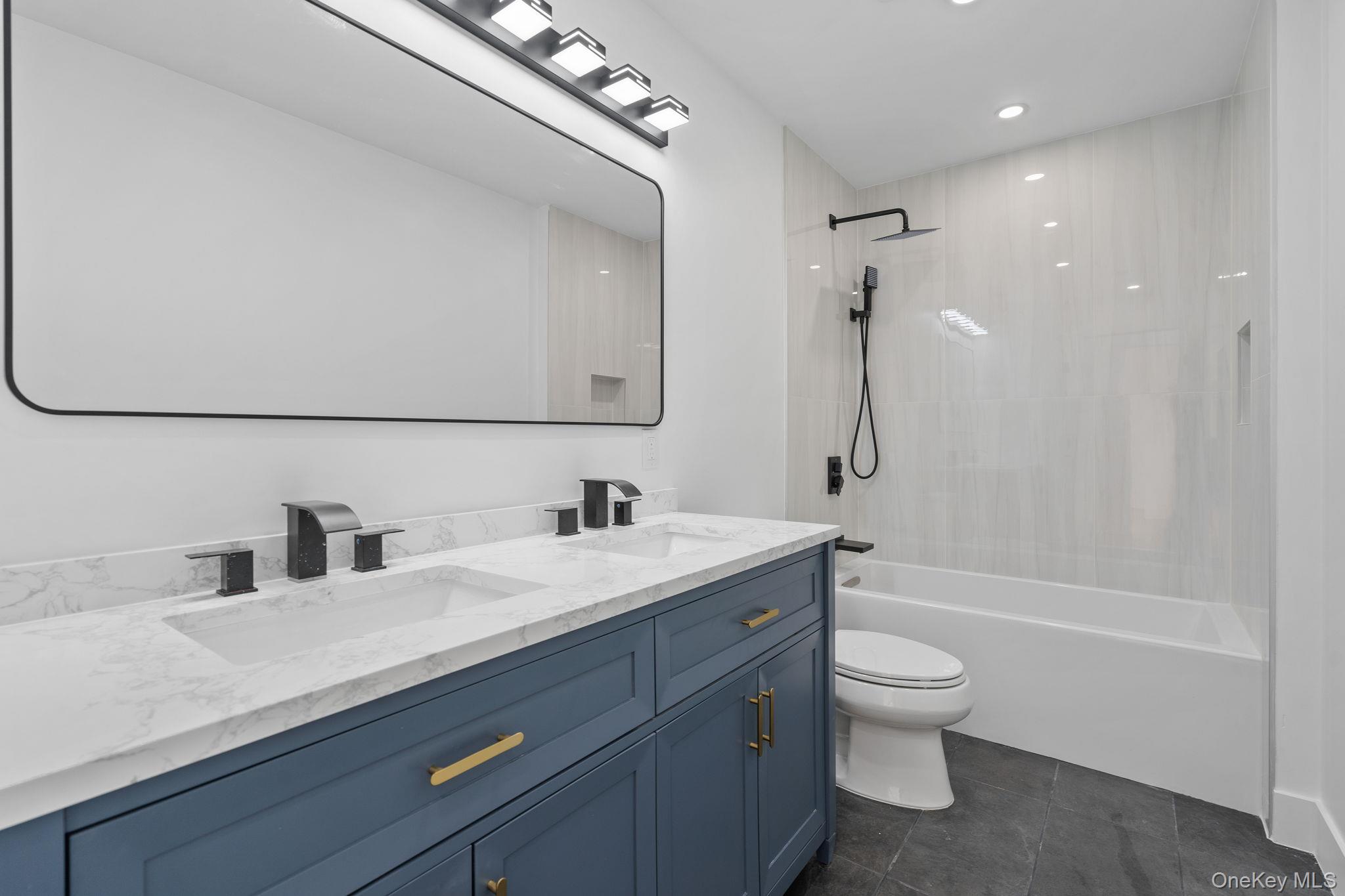 52 Rudolph Road Modena, NY 12548 - Photo 19 of 46 Full bathroom featuring double vanity, shower / bathtub combination, recessed lighting, and dark tile patterned flooring