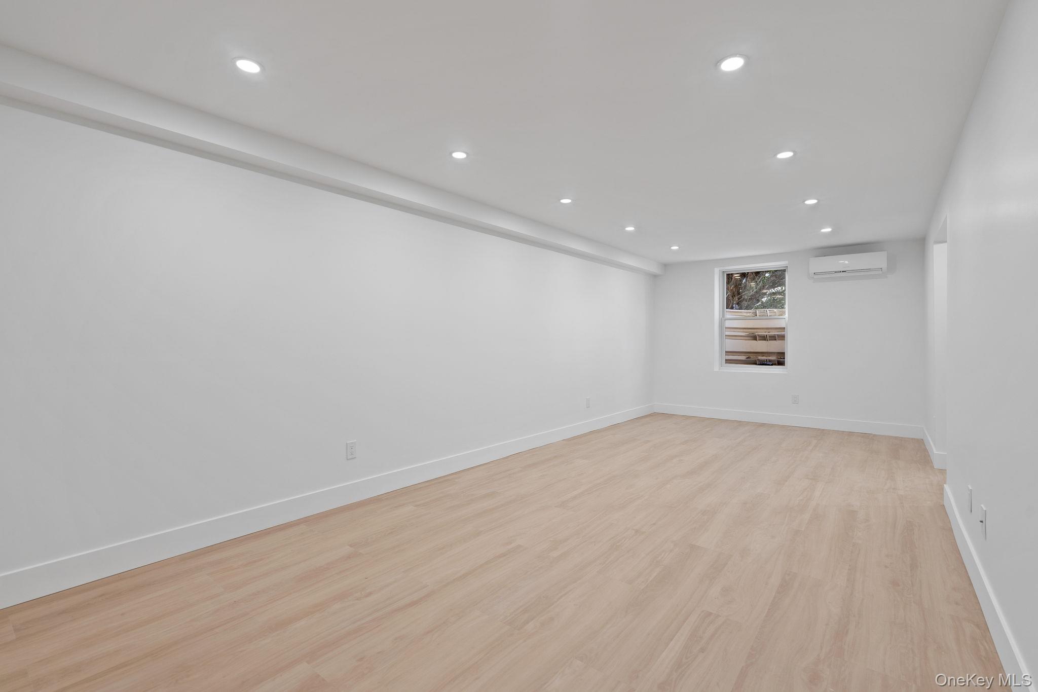 52 Rudolph Road Modena, NY 12548 - Photo 30 of 46 Spare room featuring recessed lighting, light wood-style flooring, and a wall mounted AC
