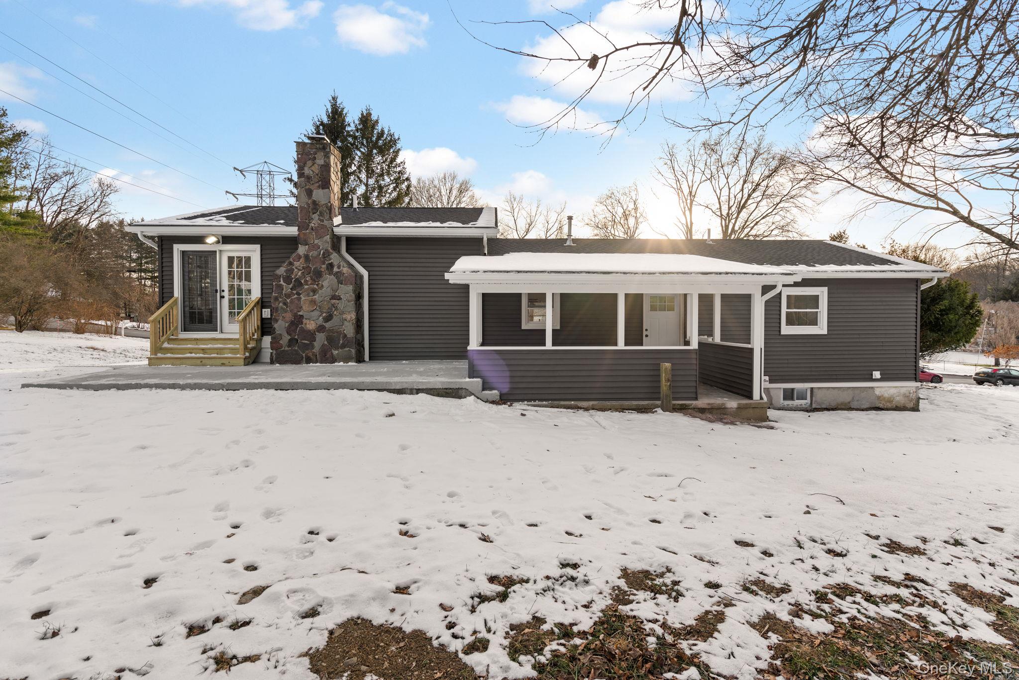 52 Rudolph Road Modena, NY 12548 - Photo 39 of 46 Snow covered house featuring a chimney and a patio area
