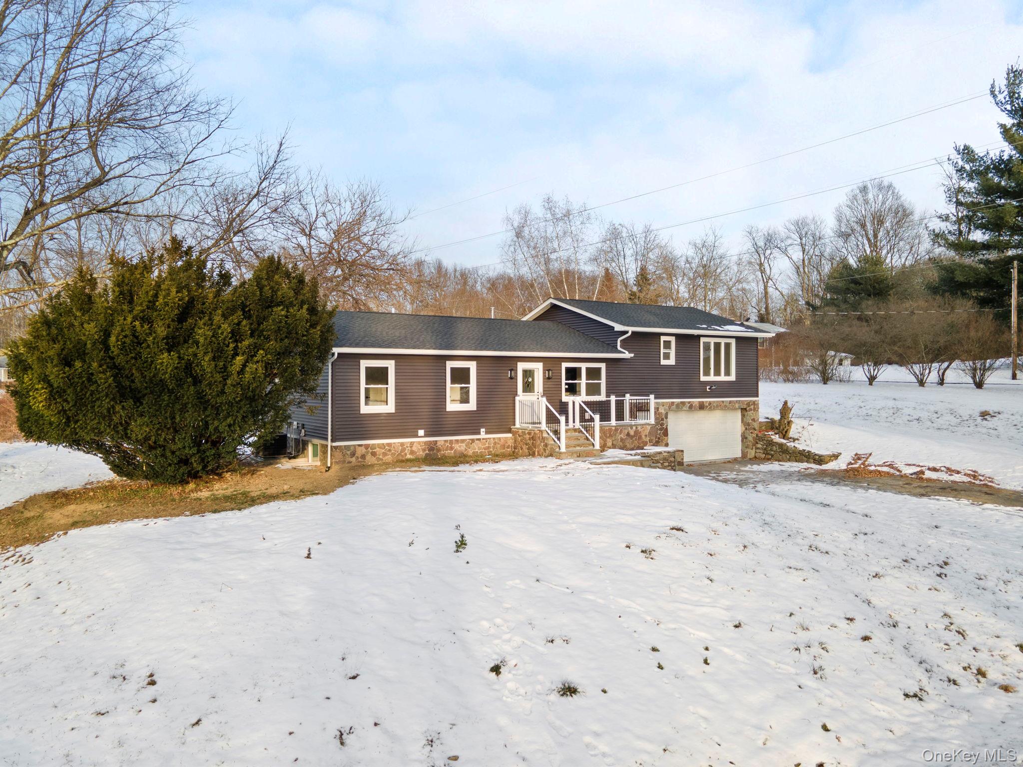 52 Rudolph Road Modena, NY 12548 - Photo 46 of 46 View of front of property with stone siding and an attached garage