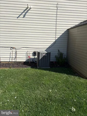 a view of a backyard with plants and brick wall