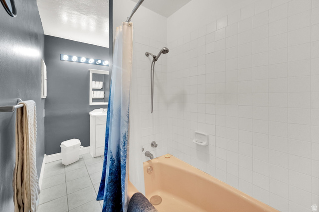 4635 Box Elder Street Murray, UT 84107 - Photo 16 of 21 Full bathroom featuring light tile patterned flooring, shower / bath combo, and vanity