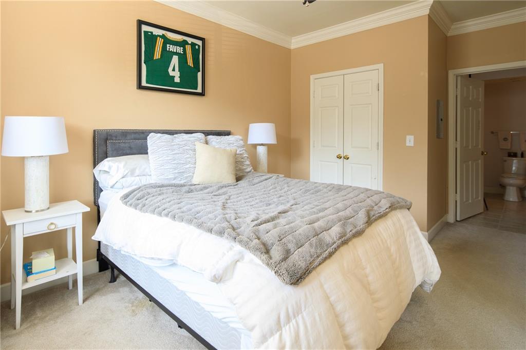 3777 Peachtree Road Northeast, Unit 715 Brookhaven, GA 30319 - Photo 14 of 17 a bedroom with a bed and lamp