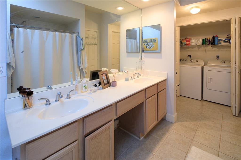 3777 Peachtree Road Northeast, Unit 715 Brookhaven, GA 30319 - Photo 16 of 17 a bathroom with a double vanity sink a mirror and a