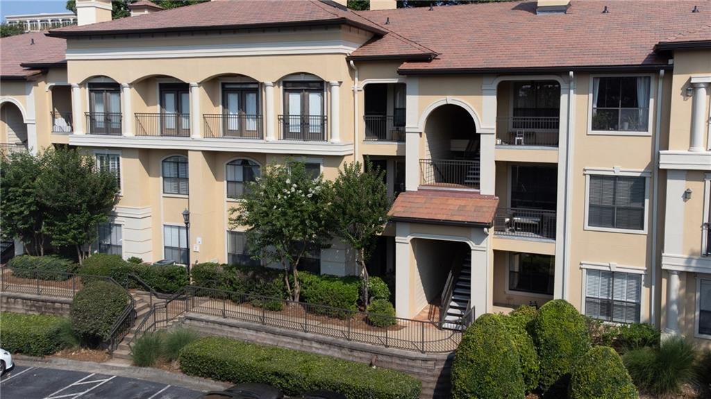 3777 Peachtree Road Northeast, Unit 715 Brookhaven, GA 30319 - Photo 2 of 17 a front view of a house with a yard