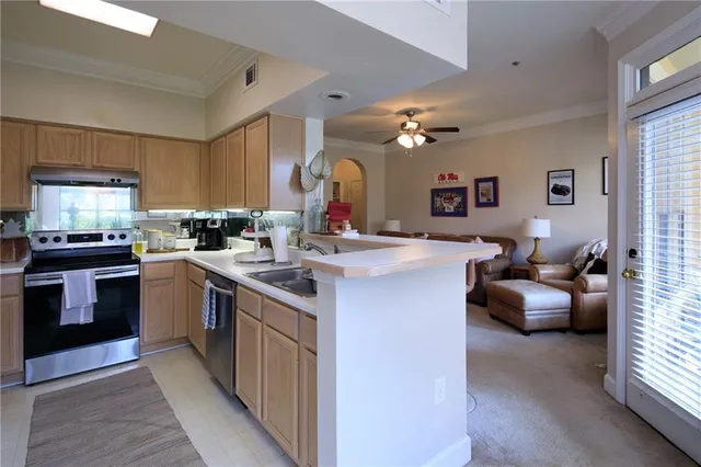 a kitchen with counter top space and living room