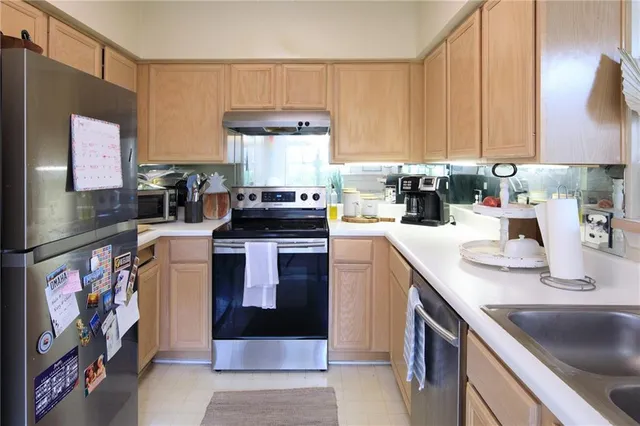 a kitchen with a stove top oven sink and cabinets