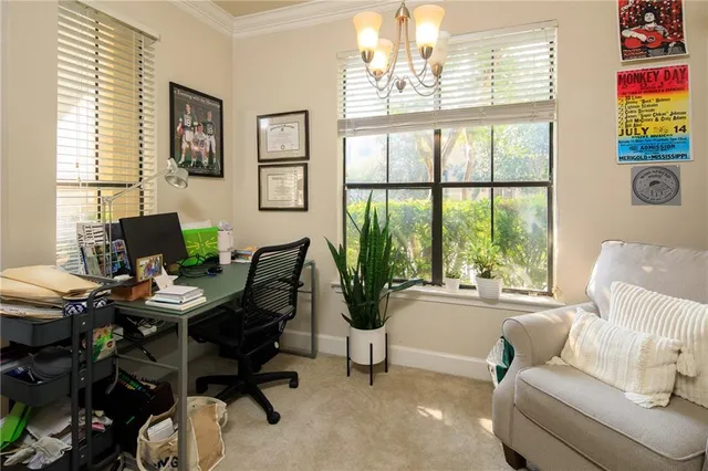 a living room with furniture and a floor to ceiling window