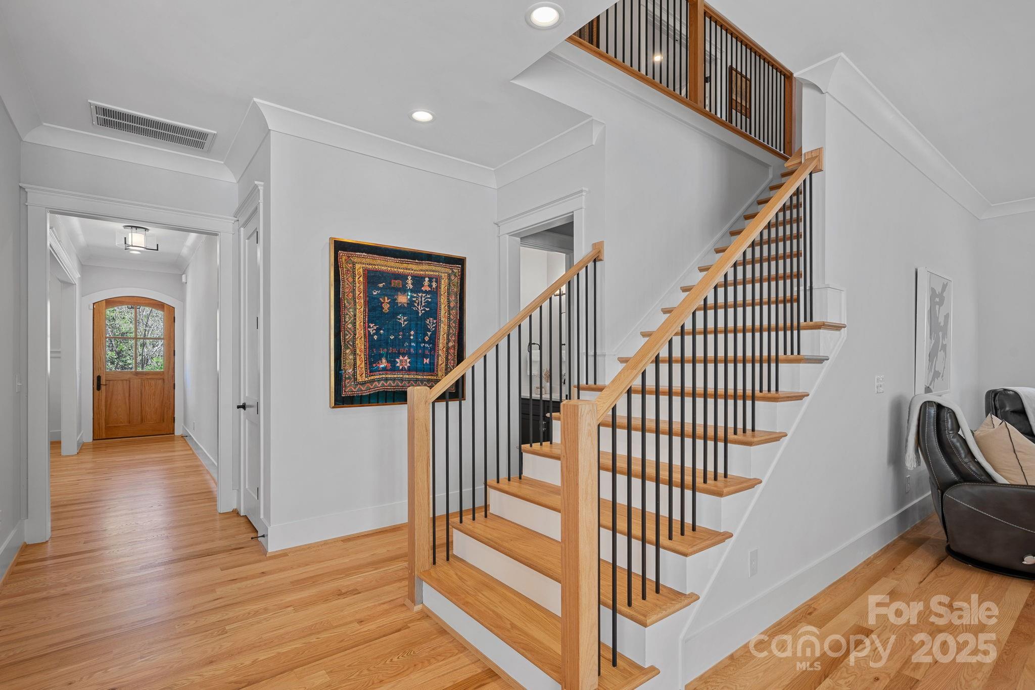 3228 East Ford Road Charlotte, NC 28205 - Photo 11 of 31 a view of a hallway with wooden floor and stairs