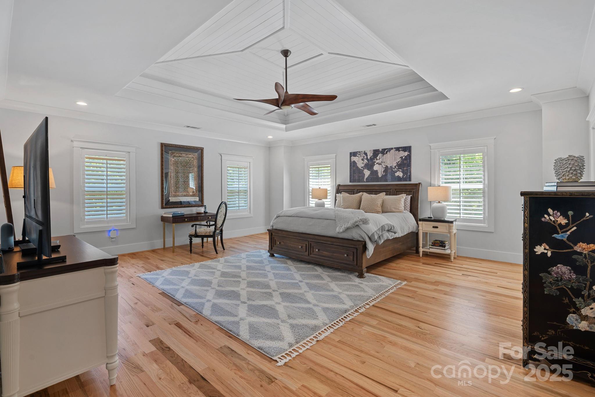 3228 East Ford Road Charlotte, NC 28205 - Photo 13 of 31 a bedroom with a bed a chandelier and a flat screen television