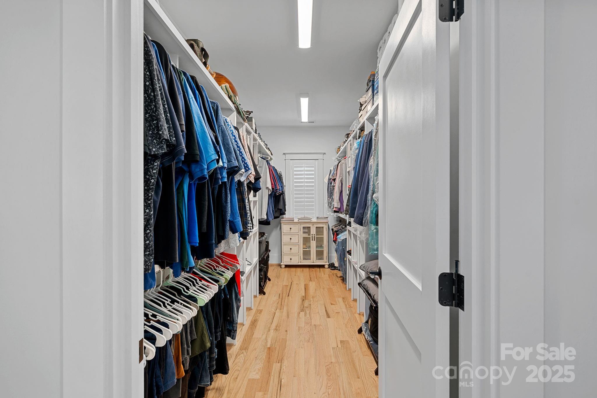 3228 East Ford Road Charlotte, NC 28205 - Photo 18 of 31 a view of walk in closet with clothes and shoes