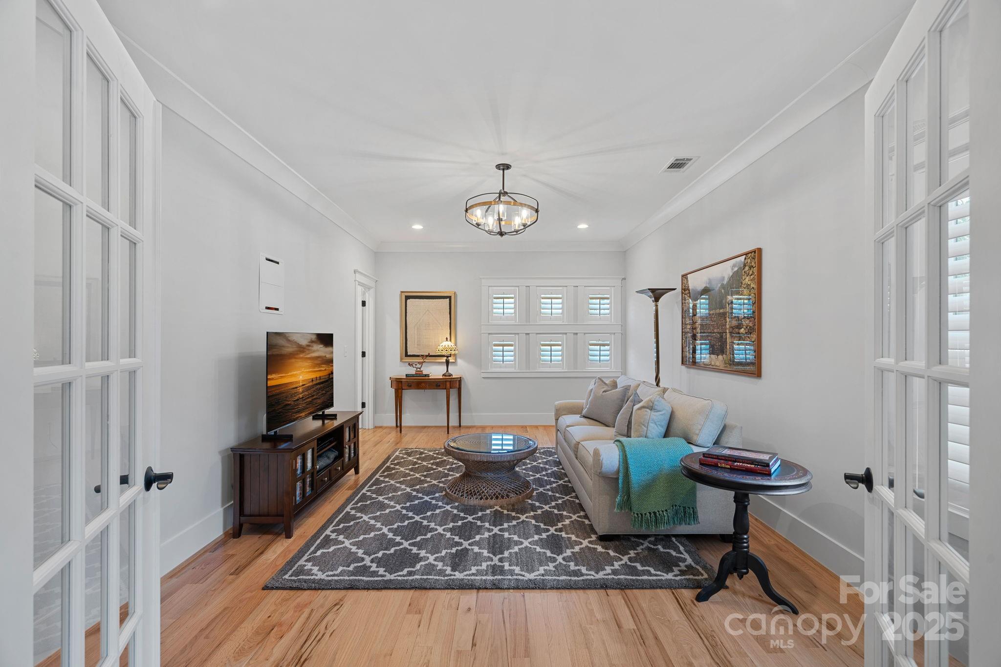 3228 East Ford Road Charlotte, NC 28205 - Photo 20 of 31 a living room with furniture and a flat screen tv