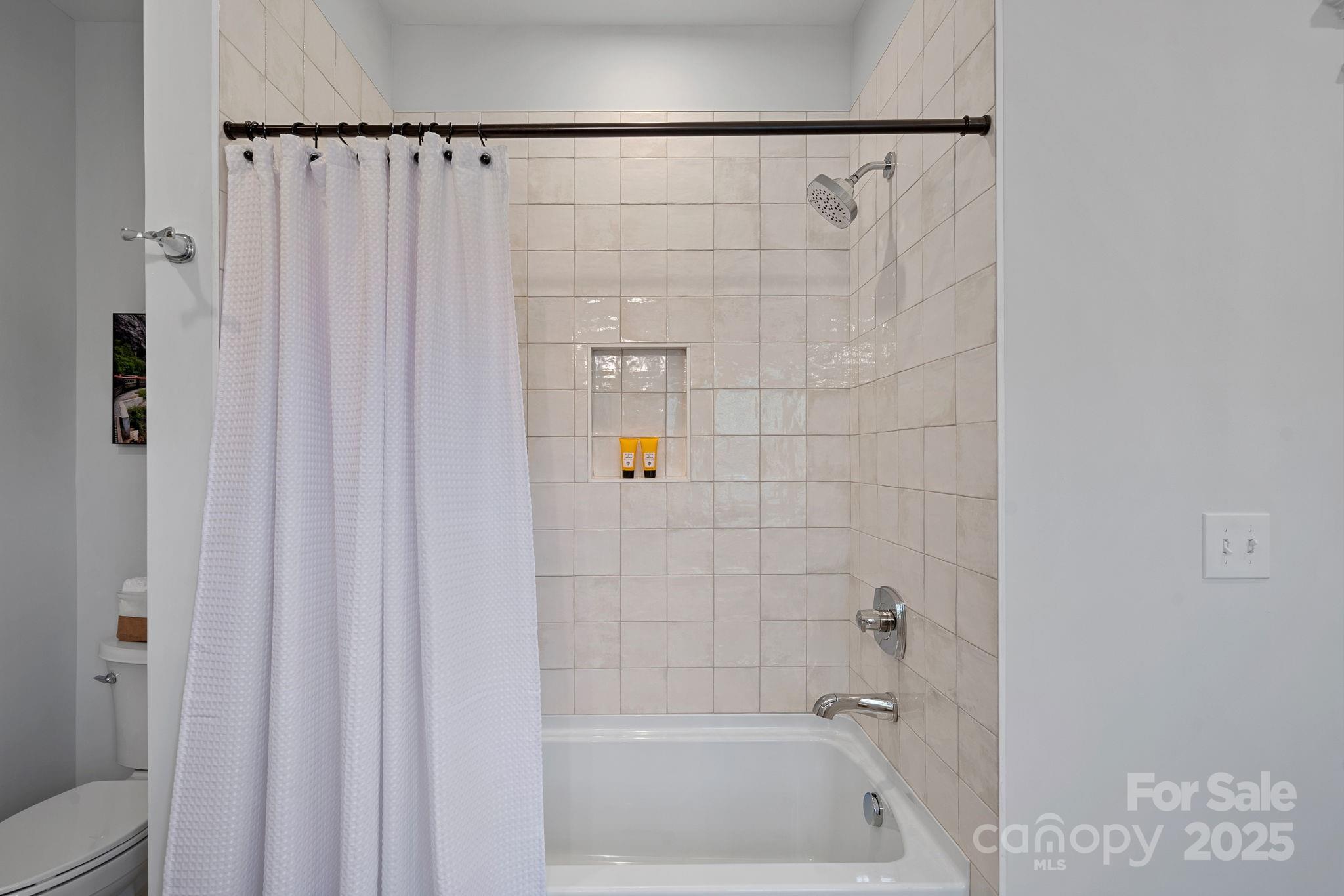 3228 East Ford Road Charlotte, NC 28205 - Photo 22 of 31 a bathroom with a shower and a bath tub