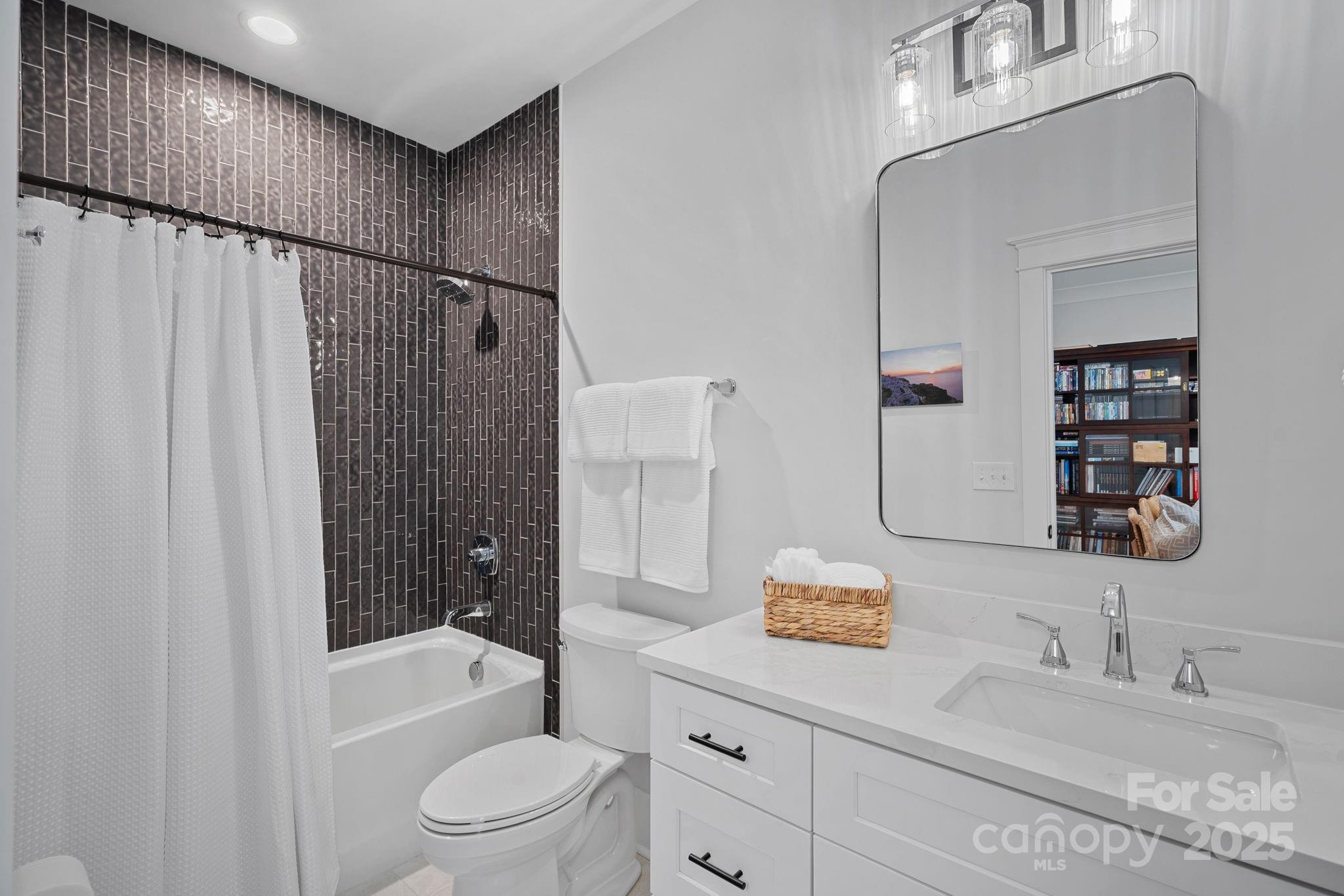 3228 East Ford Road Charlotte, NC 28205 - Photo 25 of 31 a bathroom with a granite countertop sink a toilet and shower