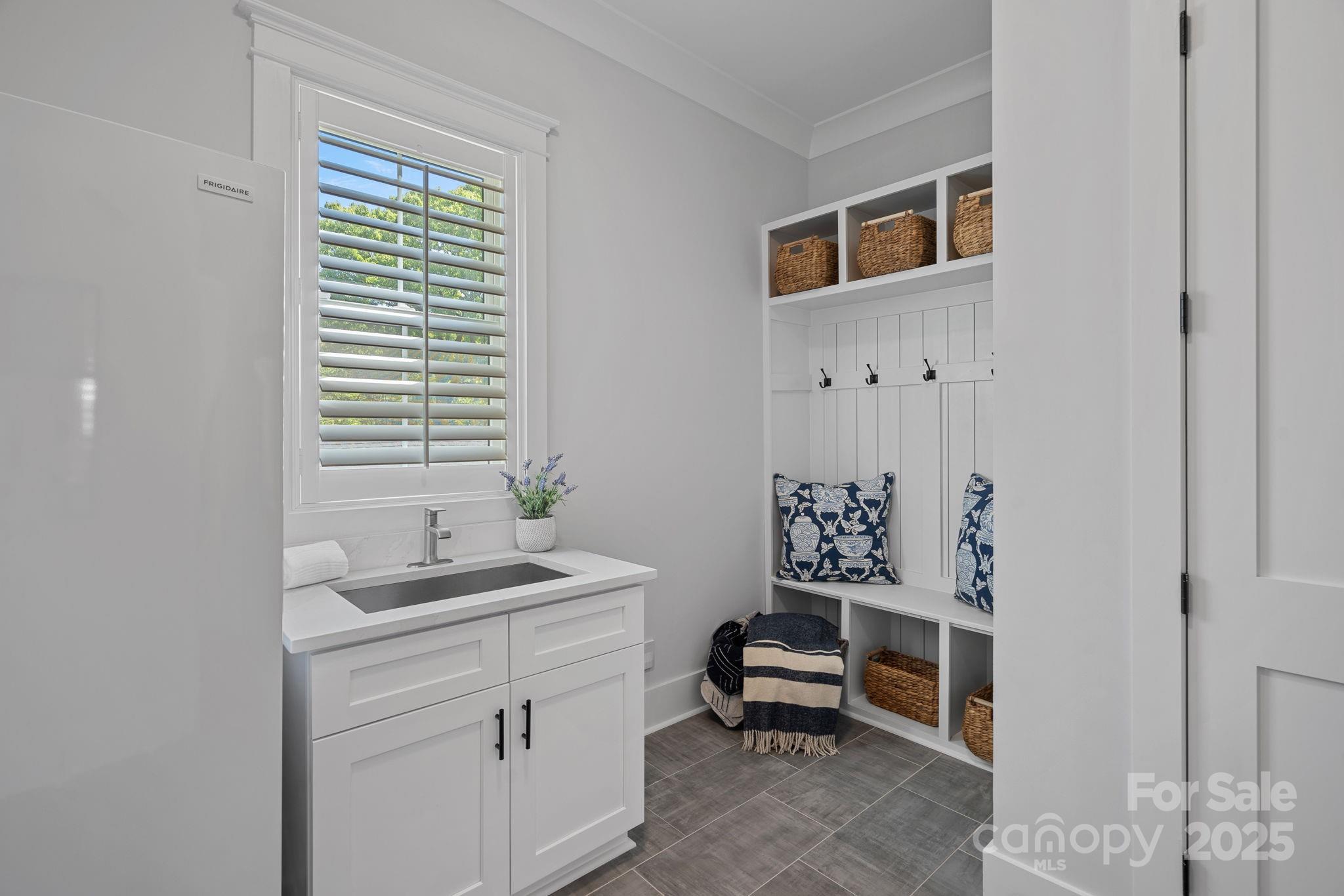 3228 East Ford Road Charlotte, NC 28205 - Photo 9 of 31 a bathroom with a sink a toilet and a window