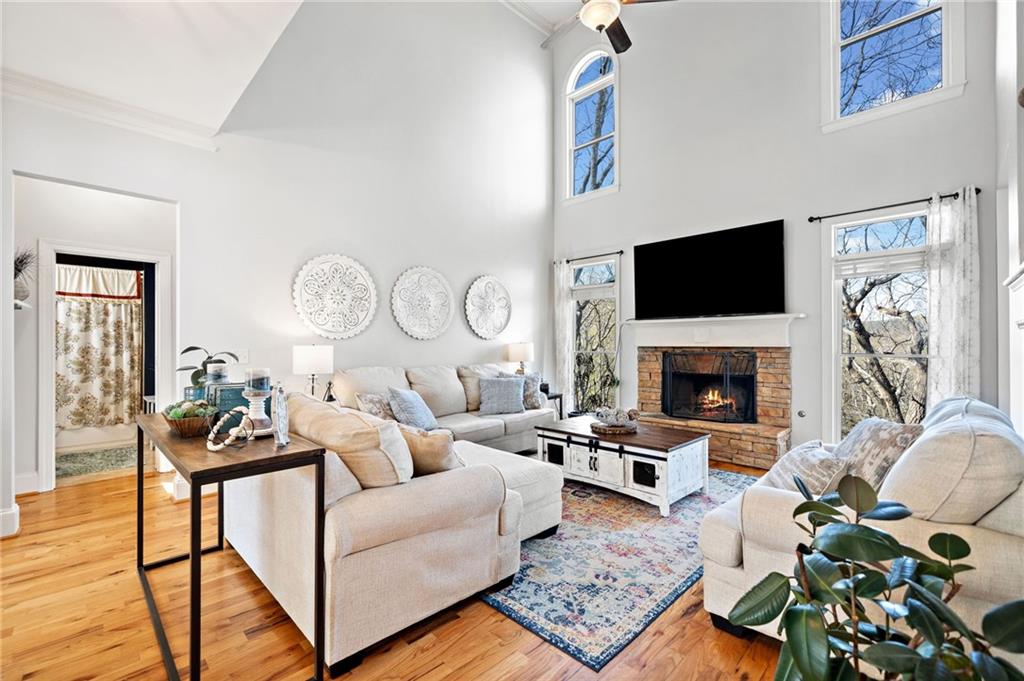121 Moose Loop Waleska, GA 30183 - Photo 13 of 57 a living room with furniture a fireplace and a flat screen tv