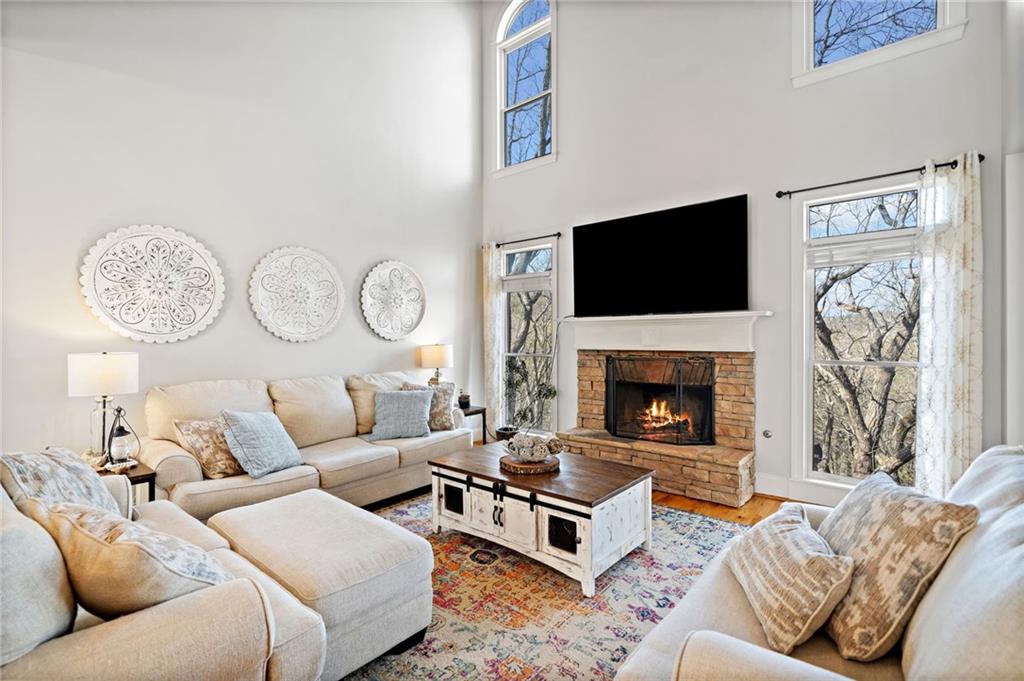 121 Moose Loop Waleska, GA 30183 - Photo 14 of 57 a living room with furniture a flat screen tv and a fireplace