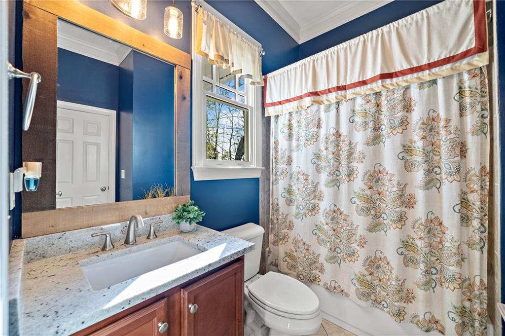 121 Moose Loop Waleska, GA 30183 - Photo 18 of 57 a bathroom with a granite countertop sink a toilet and shower curtain