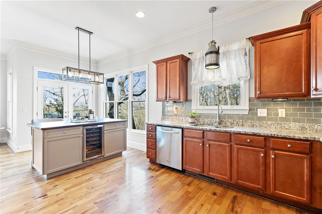 121 Moose Loop Waleska, GA 30183 - Photo 21 of 57 a kitchen with stainless steel appliances granite countertop a sink a stove and a wooden floors