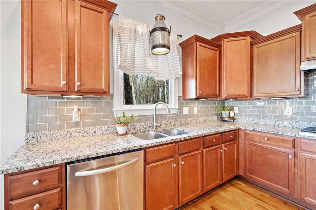 121 Moose Loop Waleska, GA 30183 - Photo 22 of 57 a kitchen with stainless steel appliances granite countertop a sink a stove and cabinets