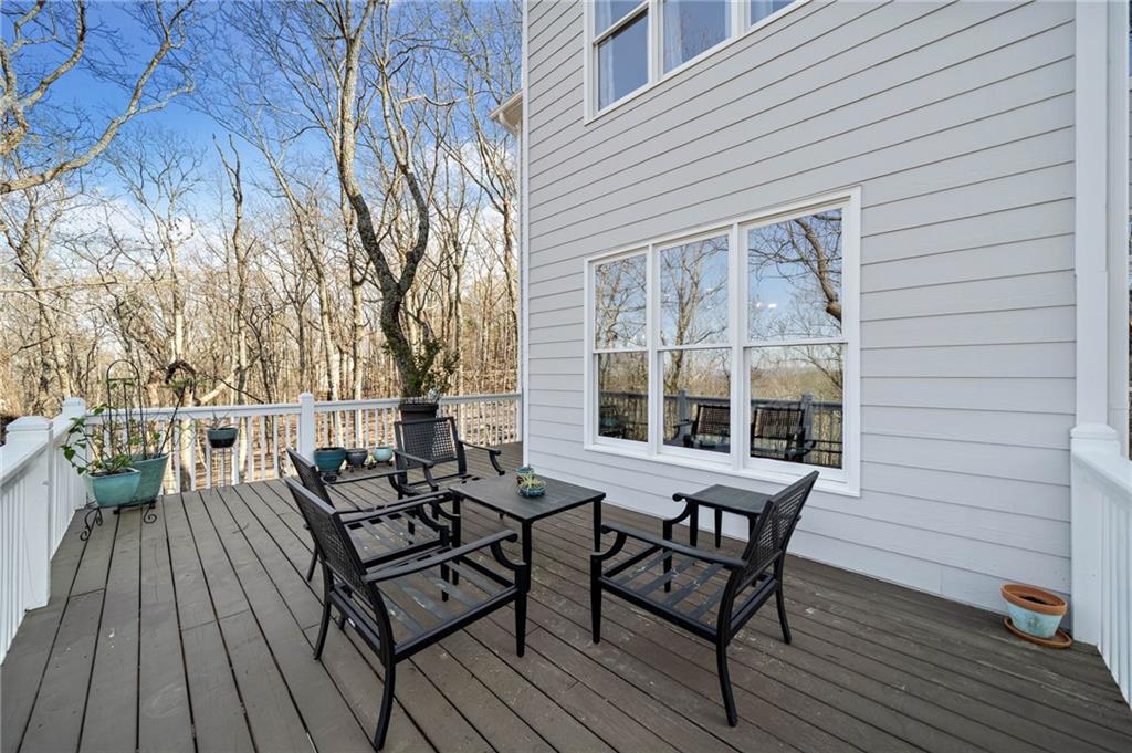 121 Moose Loop Waleska, GA 30183 - Photo 28 of 57 a view of a backyard with table and chairs and wooden floor