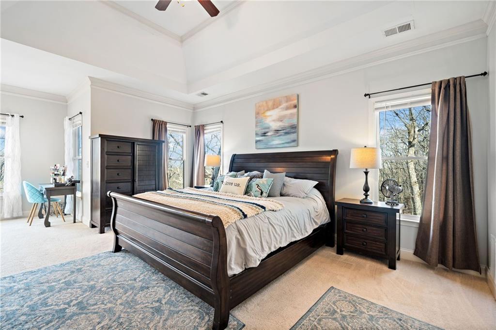 121 Moose Loop Waleska, GA 30183 - Photo 32 of 57 a bedroom with a bed and a chandelier