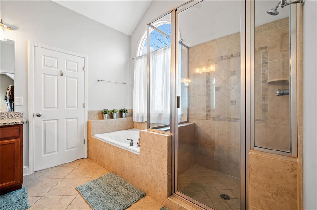 121 Moose Loop Waleska, GA 30183 - Photo 35 of 57 a bathroom with a bathtub and a shower