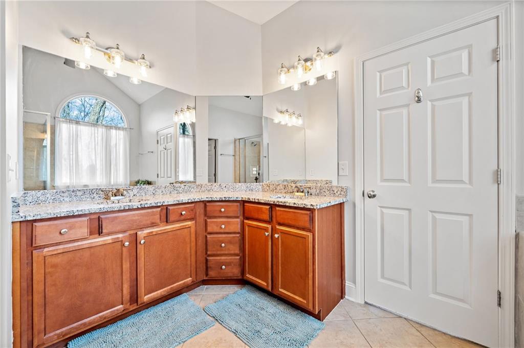 121 Moose Loop Waleska, GA 30183 - Photo 36 of 57 a spacious bathroom with a granite countertop double vanity sink mirror and