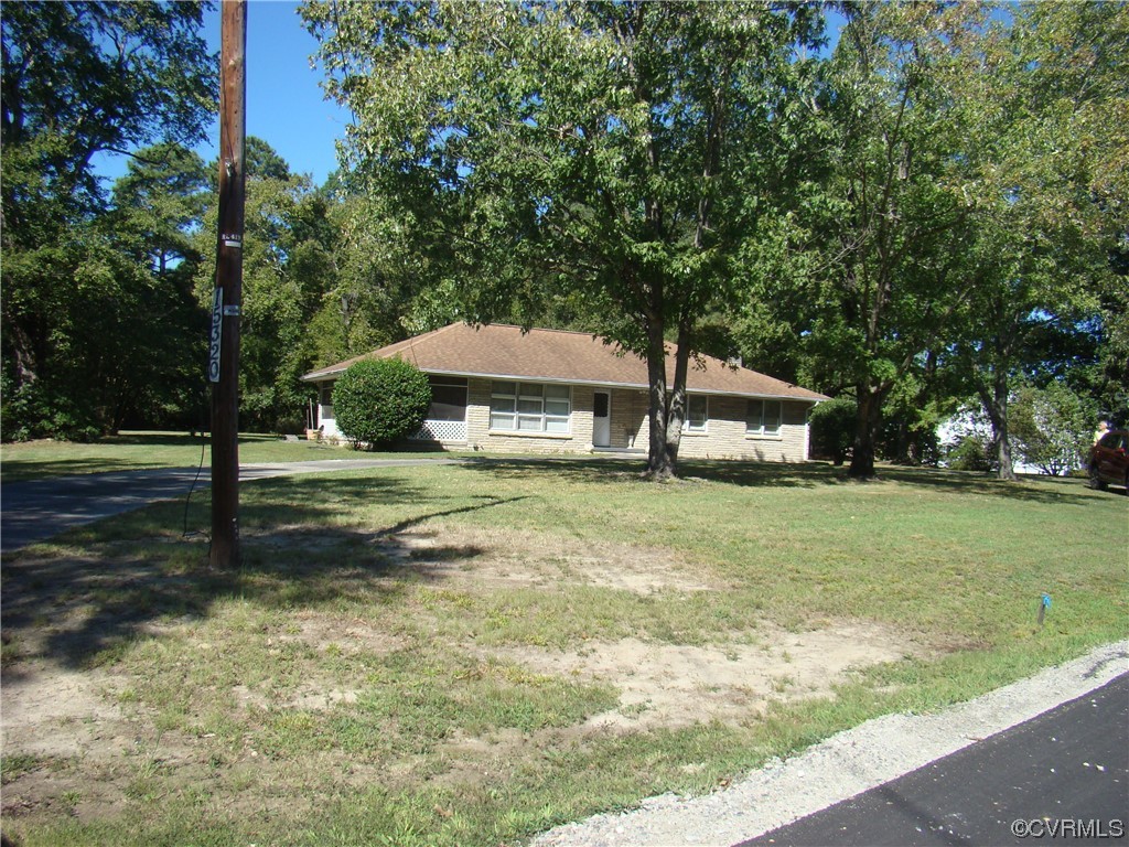 15320 Harrowgate Road Chester, VA 23831 - Photo 27 of 28 a house with trees in the background