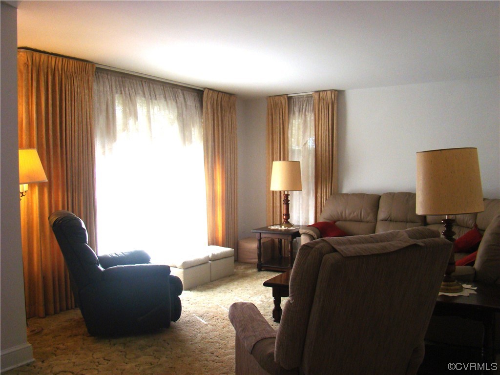 15320 Harrowgate Road Chester, VA 23831 - Photo 3 of 28 a living room with furniture and a lamp