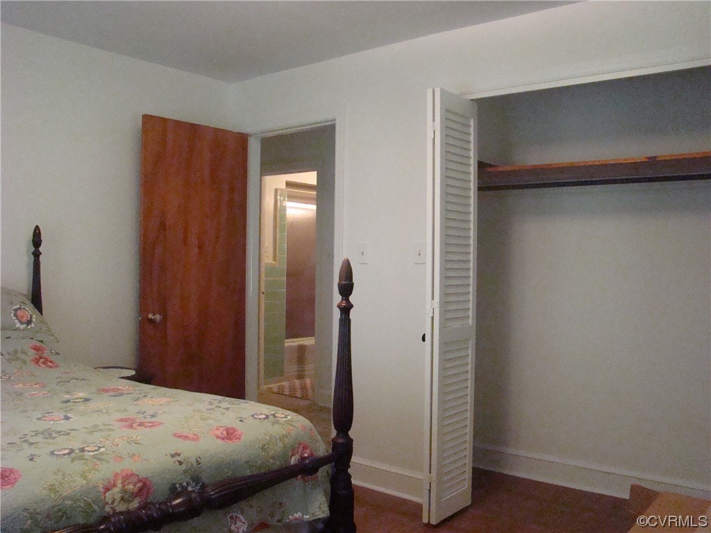 15320 Harrowgate Road Chester, VA 23831 - Photo 5 of 28 a bedroom with a bed and a table in it
